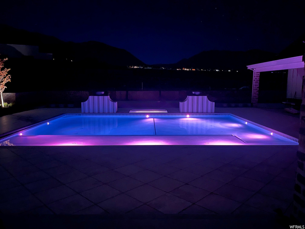 Pool at twilight with a patio