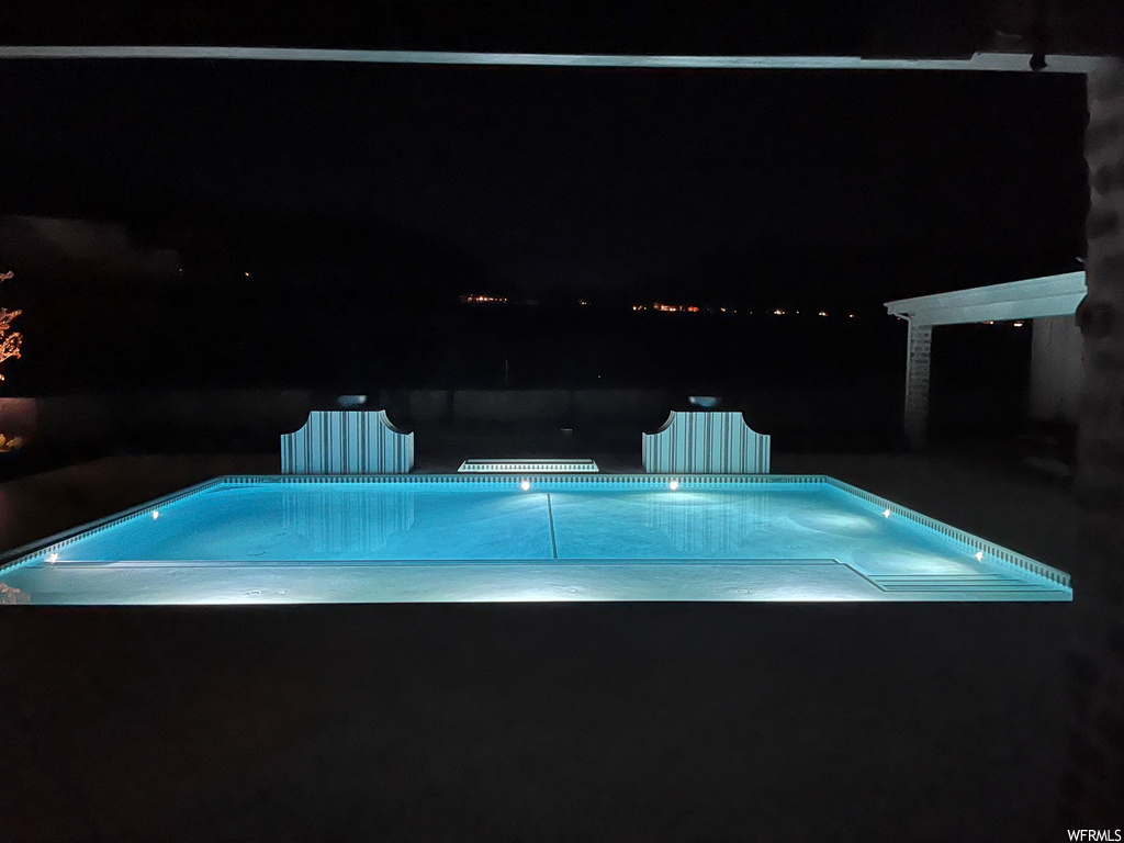 View of pool at twilight