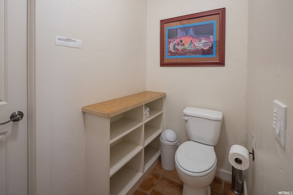 Bathroom featuring toilet and tile floors