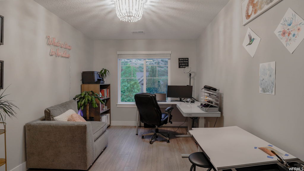 Office space featuring light hardwood / wood-style floors