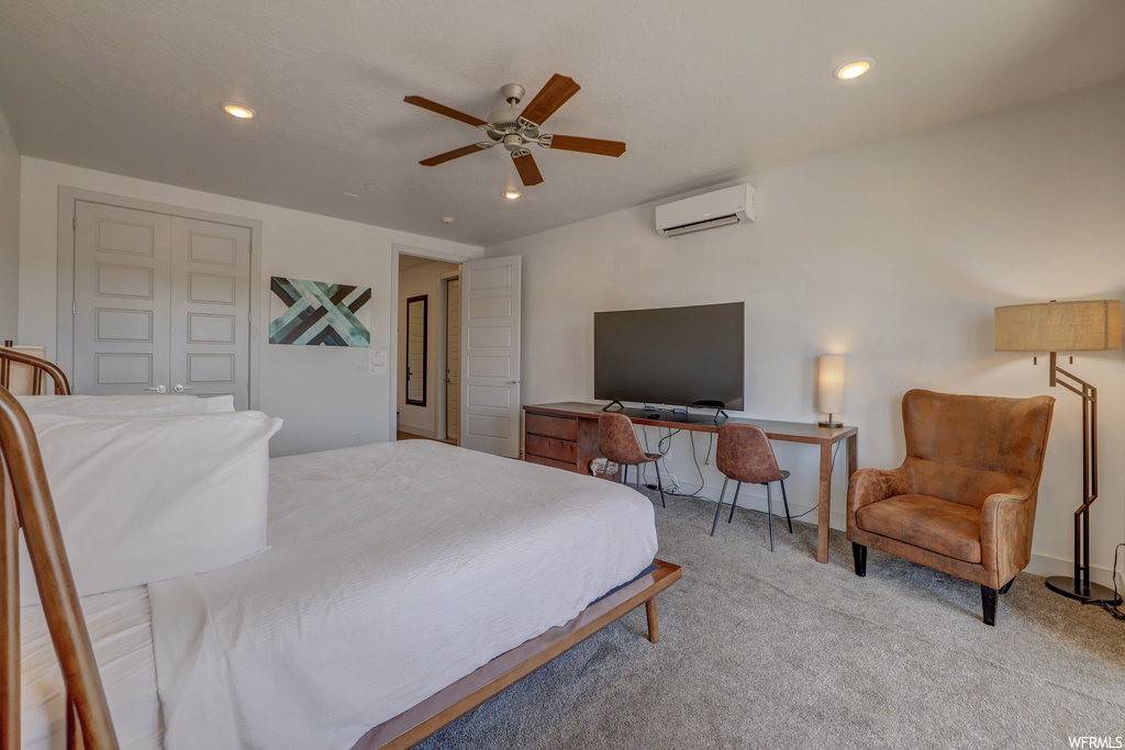 Bedroom featuring light carpet, an AC wall unit, and ceiling fan