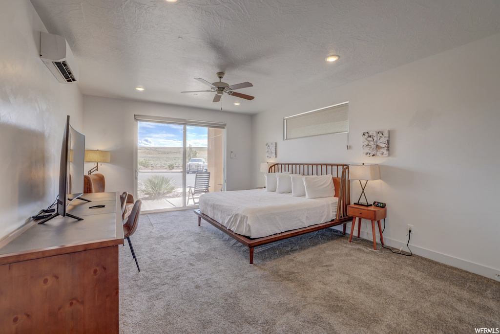 Bedroom featuring access to exterior, ceiling fan, light colored carpet, and an AC wall unit