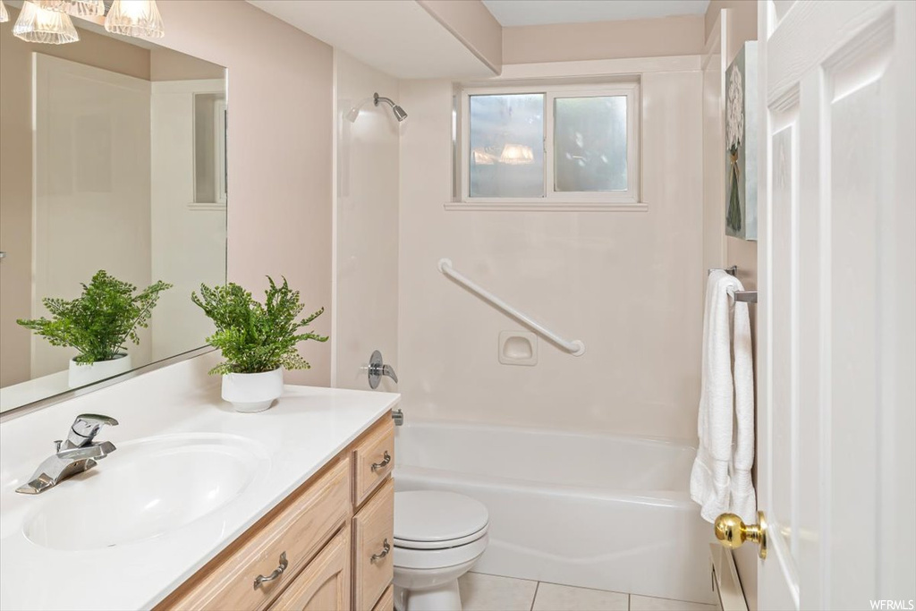 Full bathroom featuring vanity, tile flooring, toilet, and bathtub / shower combination