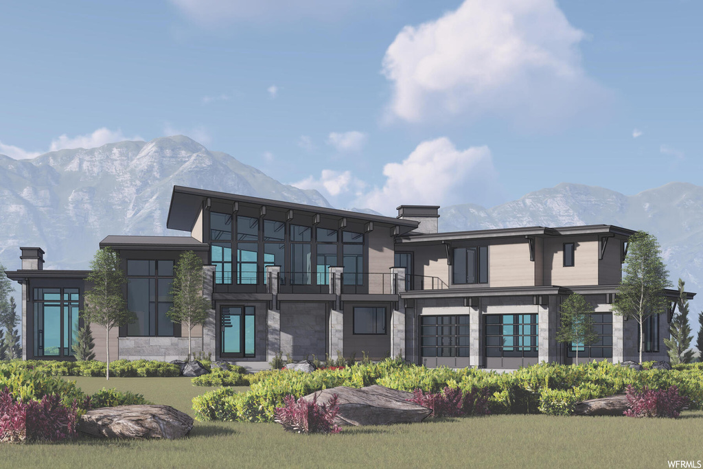 Back of property with a mountain view and a balcony