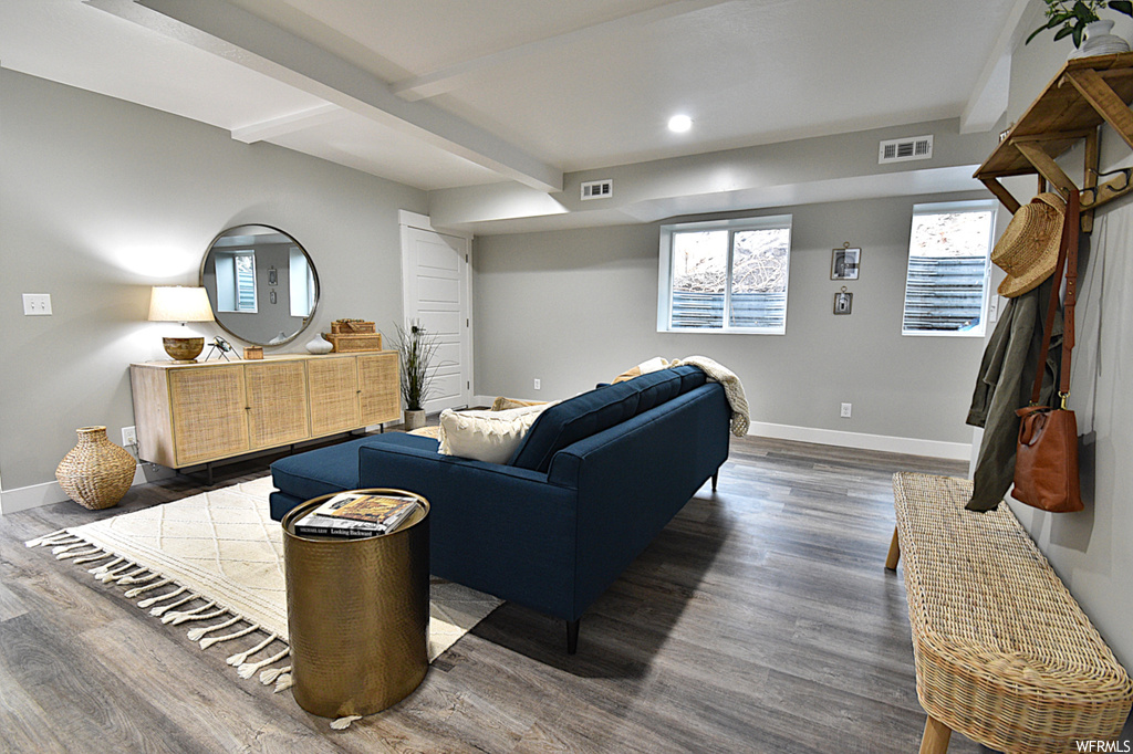 Living room featuring beam ceiling and dark hardwood / wood-style floors