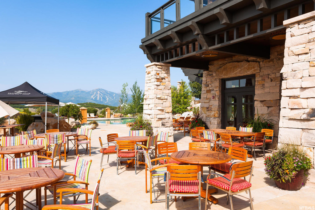 View of patio featuring a mountain view and a community pool