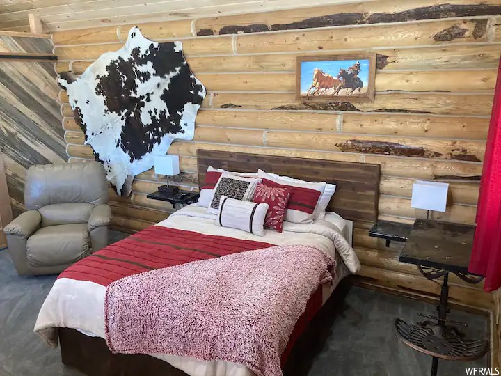 Bedroom featuring rustic walls