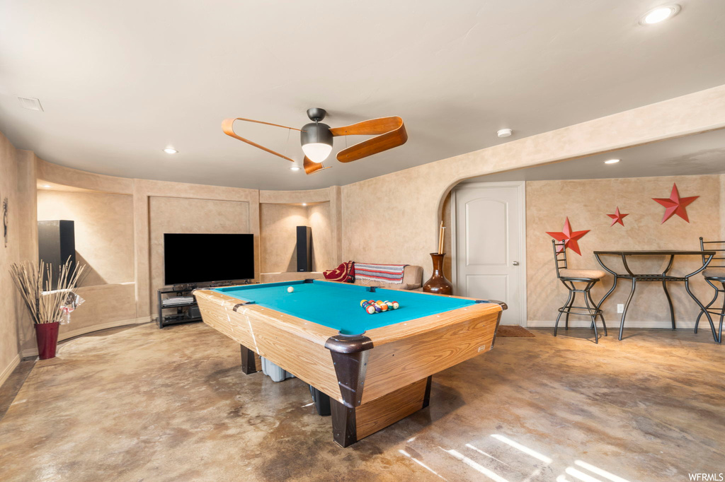 Recreation room featuring billiards, ceiling fan, and concrete flooring