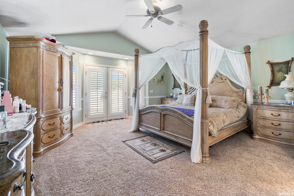 Carpeted bedroom featuring french doors, ceiling fan, vaulted ceiling, and access to outside