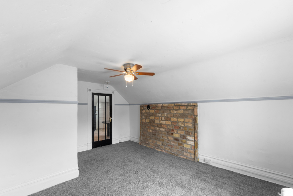 Bonus room featuring carpet floors, vaulted ceiling, and ceiling fan