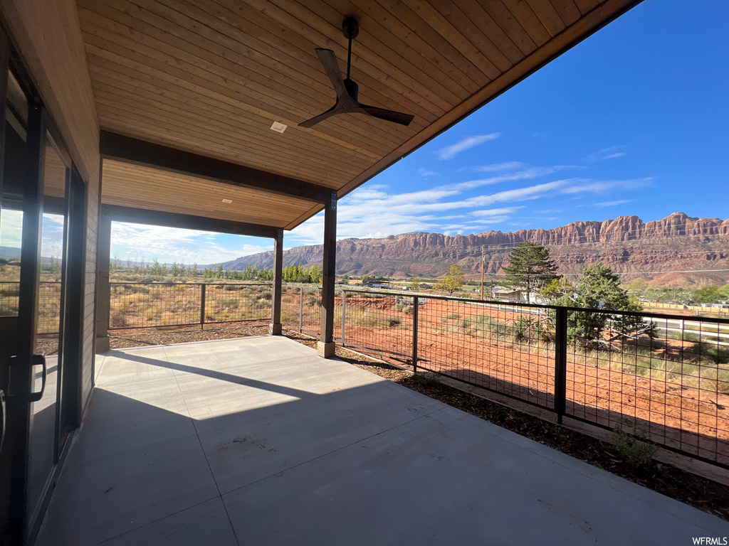 View of patio / terrace featuring a mountain view and ceiling fan