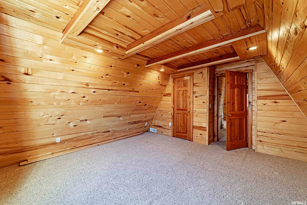 Bonus room featuring light carpet, beamed ceiling, and wood ceiling