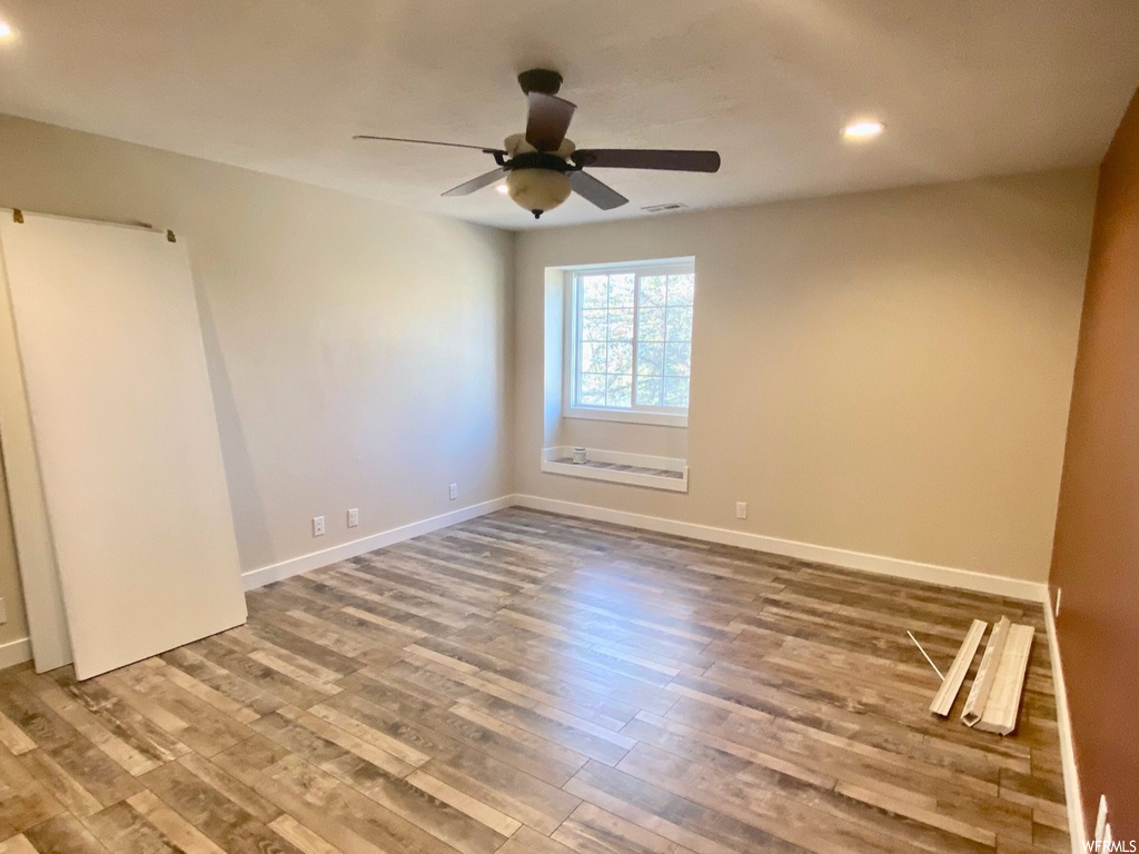 Spare room featuring ceiling fan and light wood-type flooring