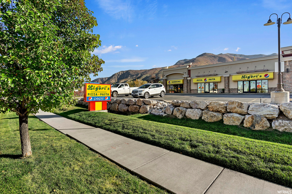 Exterior space with a mountain view and a lawn