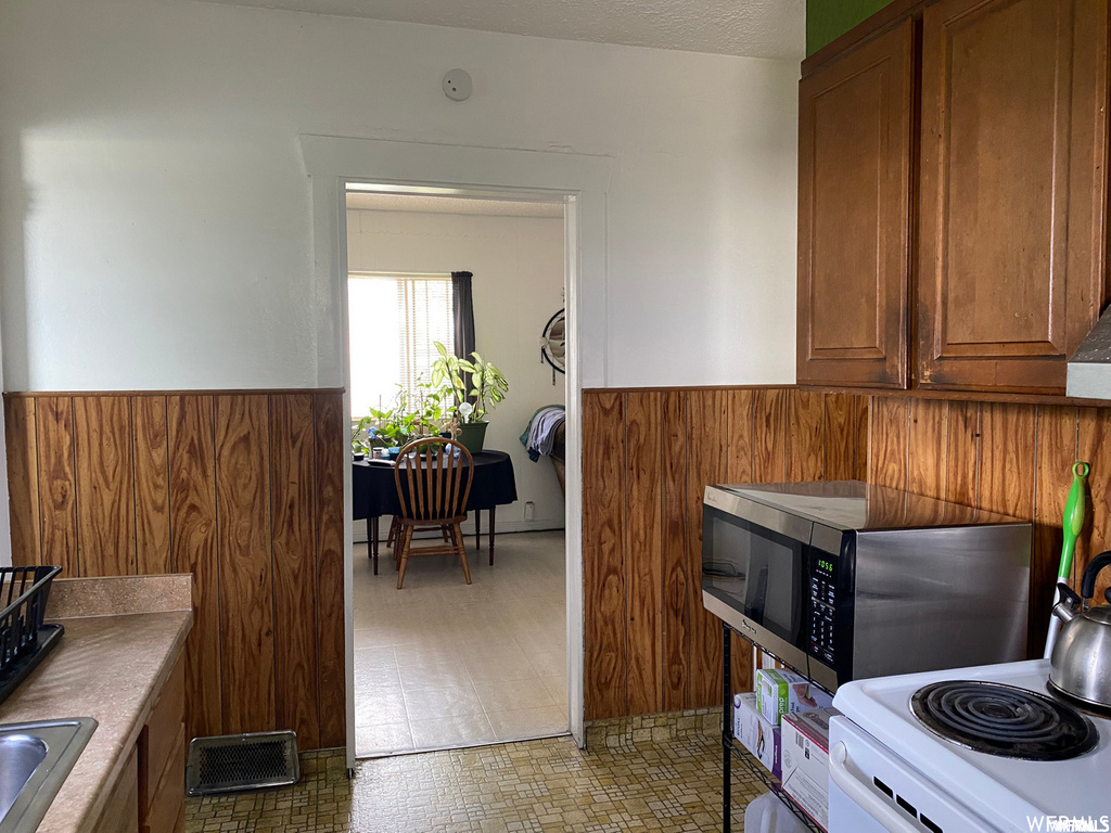 Kitchen featuring range and light tile floors