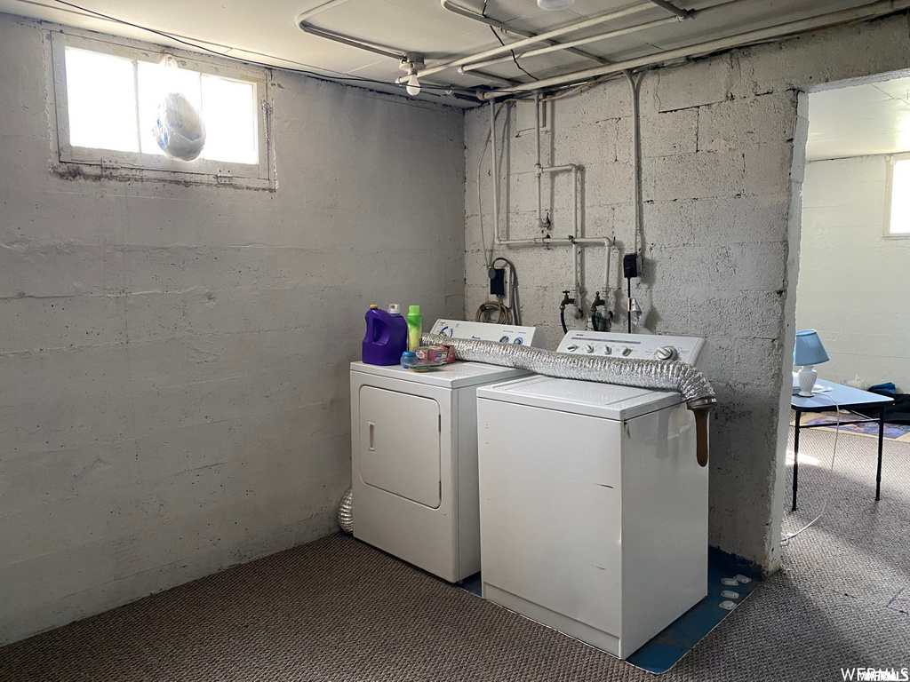Clothes washing area featuring hookup for a washing machine and independent washer and dryer