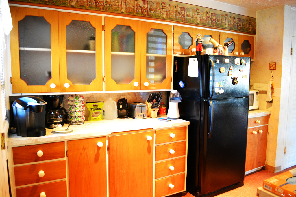 Kitchen featuring black fridge
