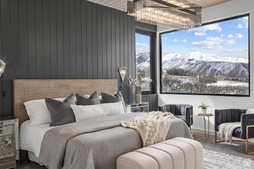 Bedroom featuring an inviting chandelier and a mountain view