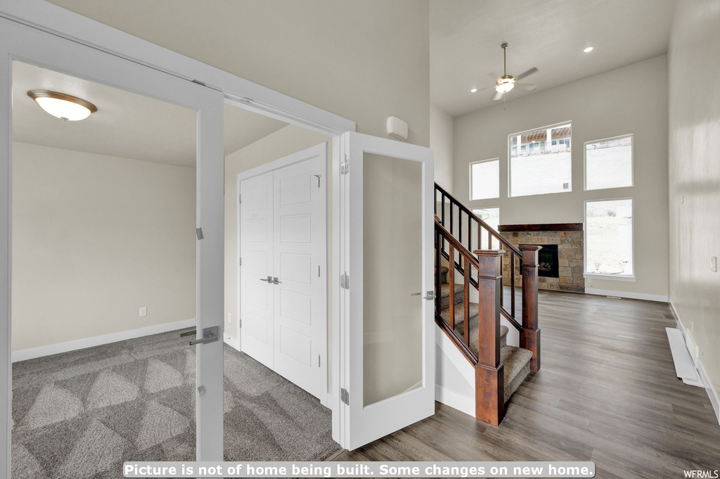 Foyer featuring plenty of natural light, ceiling fan, a fireplace, and dark hardwood / wood-style floors