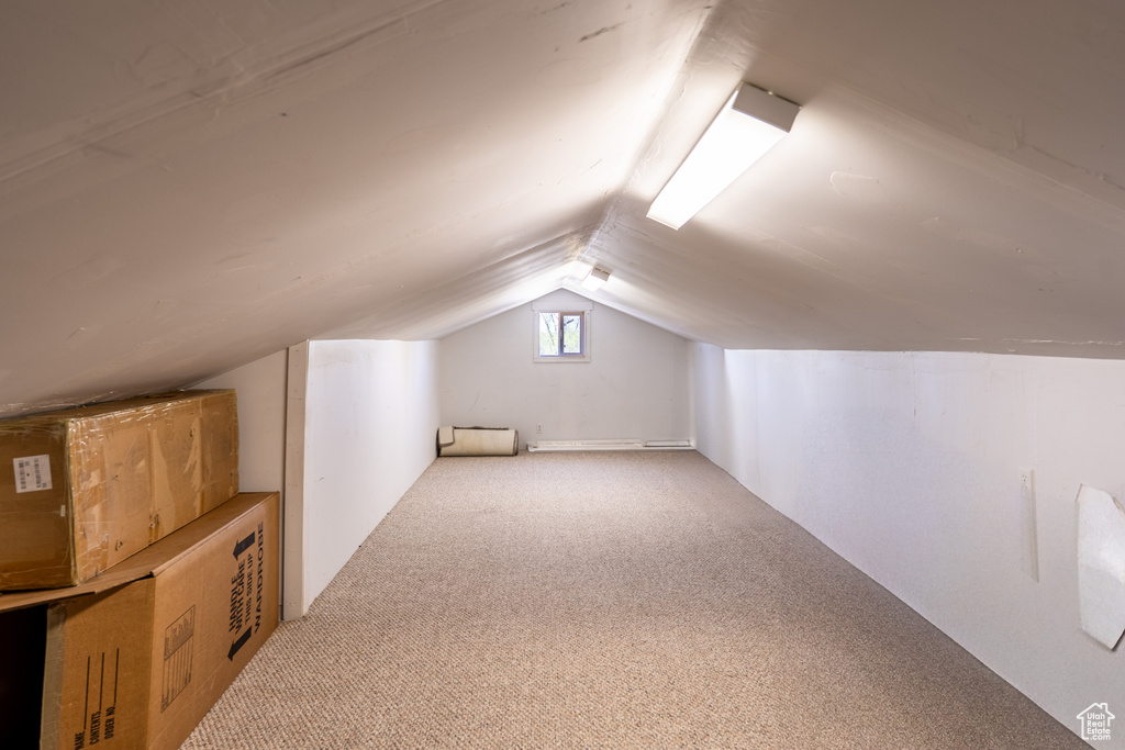Bonus room featuring lofted ceiling and carpet