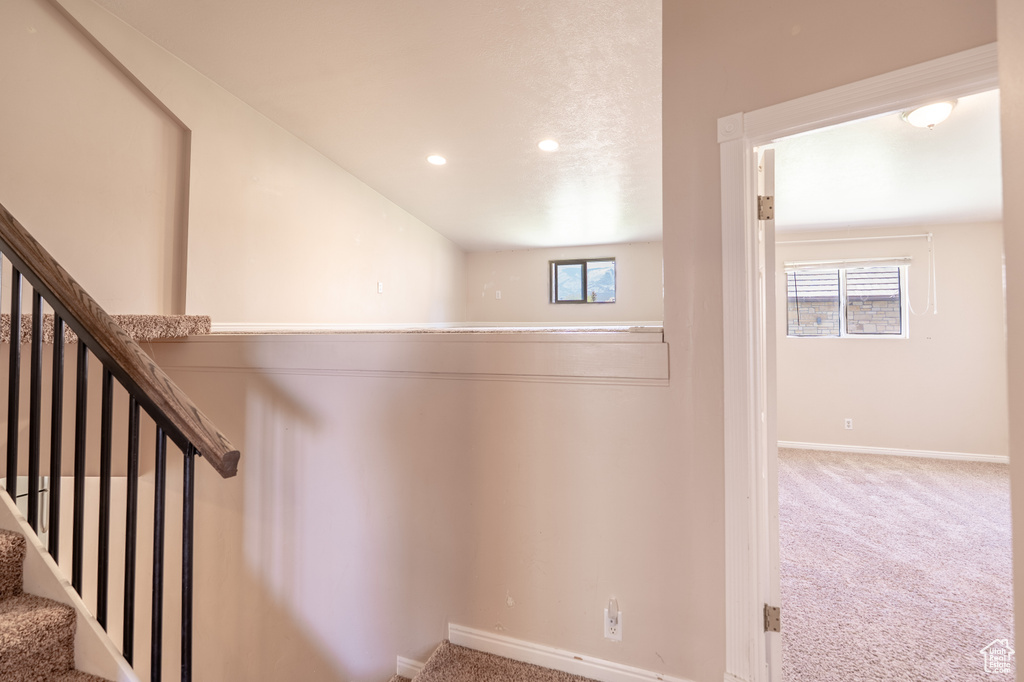 Staircase featuring carpet flooring, baseboards, healthy amount of natural light, and recessed lighting