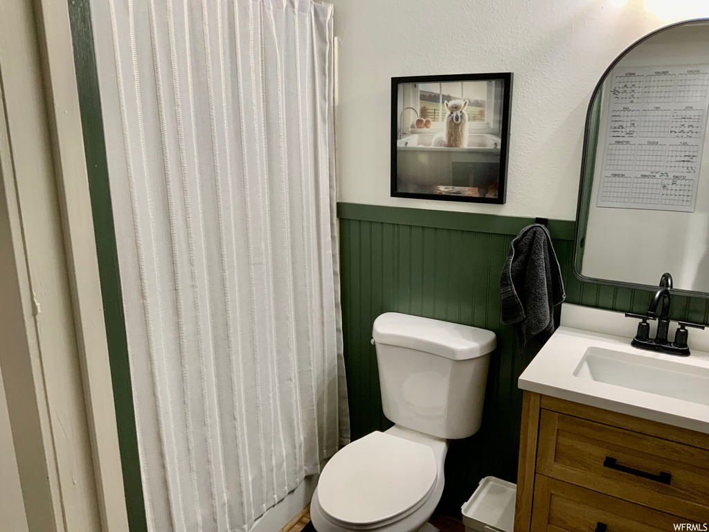 Bathroom with large vanity and toilet