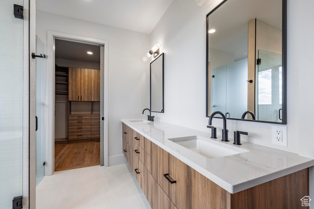 Bathroom featuring wood-type flooring and double vanity