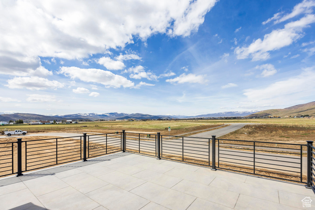 View of patio / terrace featuring a mountain view and a rural view