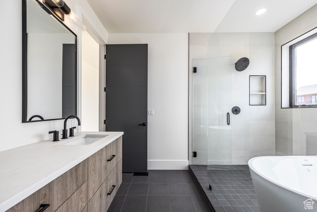 Bathroom featuring vanity, tile patterned floors, and independent shower and bath