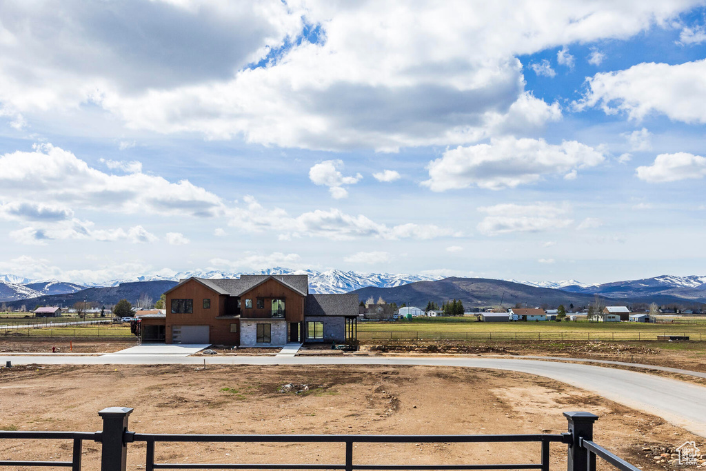 View of front of home featuring a mountain view and a rural view