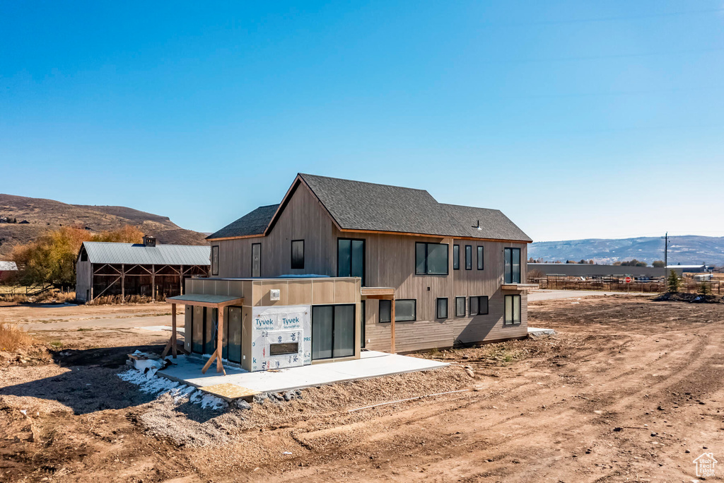 Back of house with a mountain view