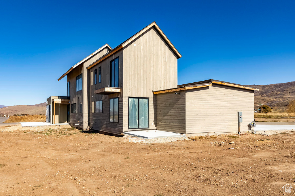 Rear view of house featuring a mountain view