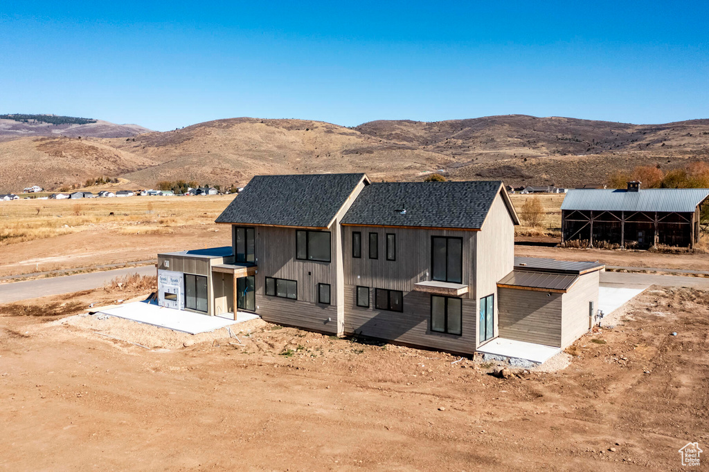 Back of property with a mountain view