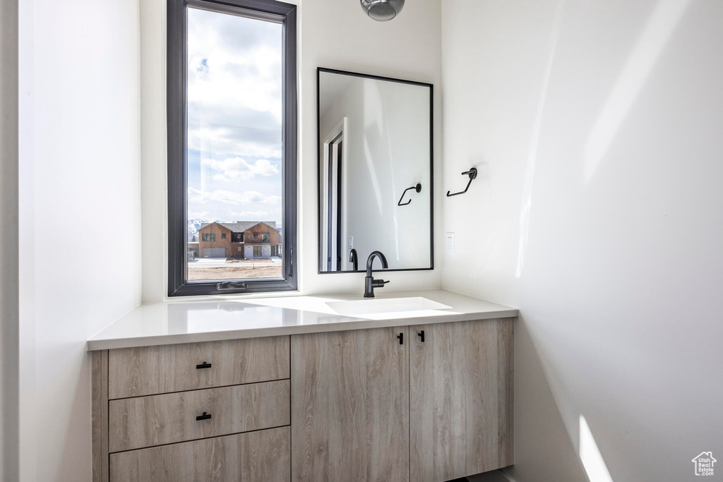 Bathroom featuring vanity and a healthy amount of sunlight