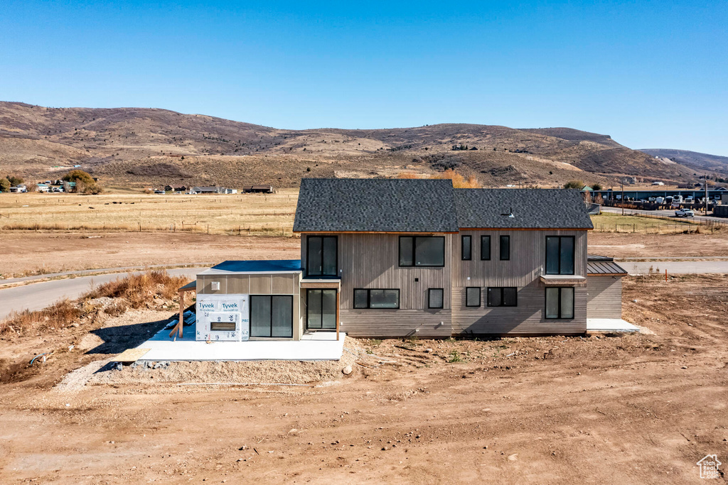 Back of house featuring a mountain view