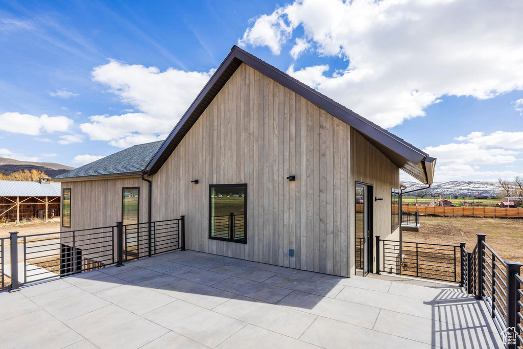 Back of house with an outbuilding and a mountain view