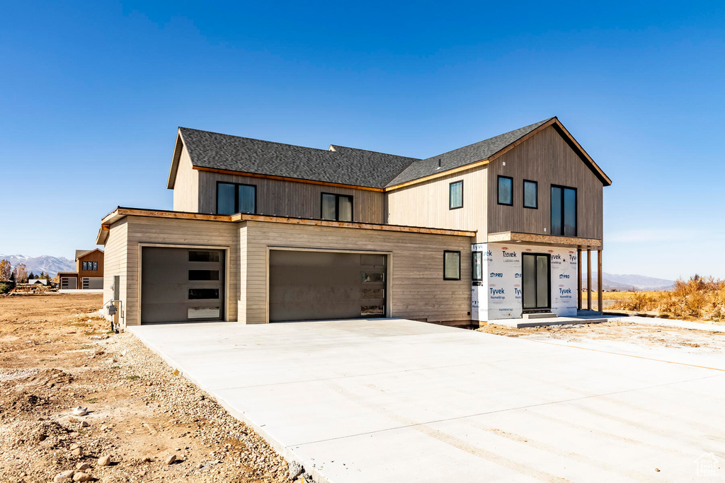 View of front facade featuring a garage and a mountain view