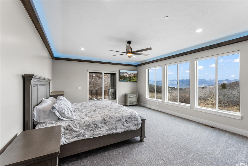 Bedroom featuring a mountain view, access to outside, light colored carpet, ceiling fan, and ornamental molding