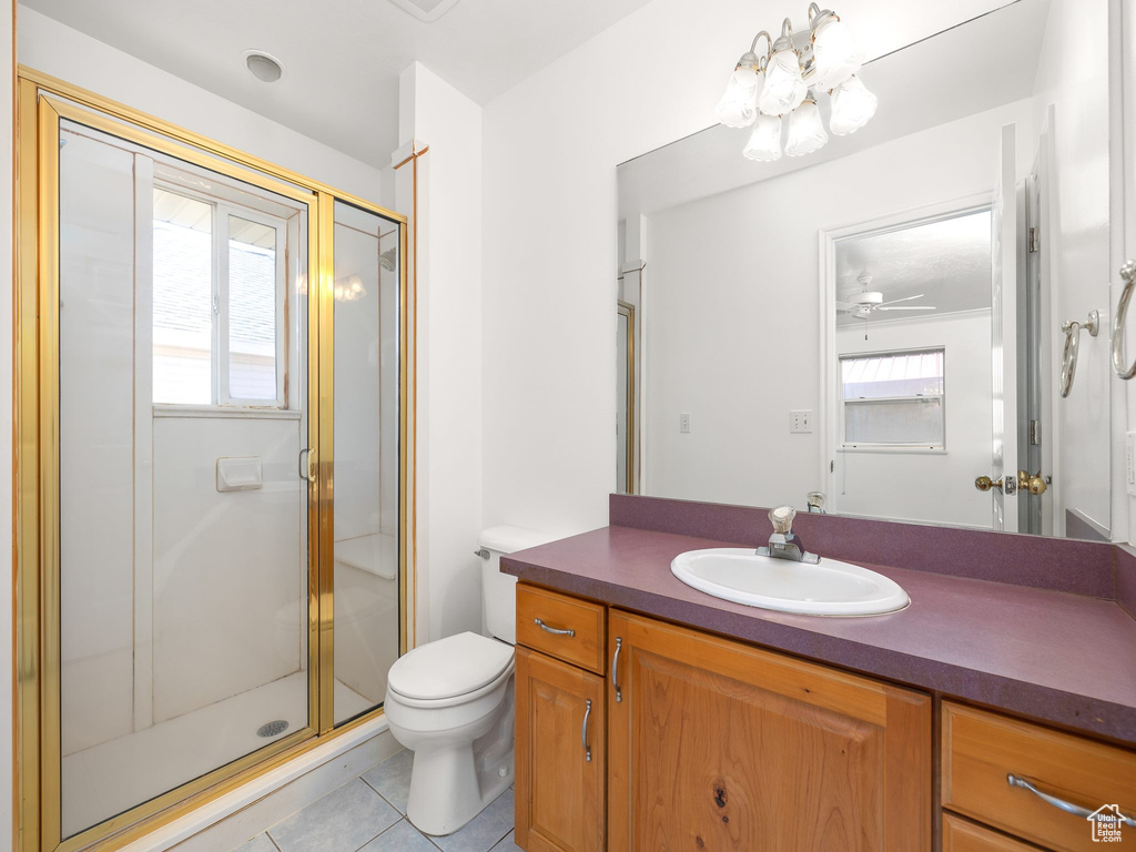Bathroom with plenty of natural light, toilet, tile floors, and vanity with extensive cabinet space