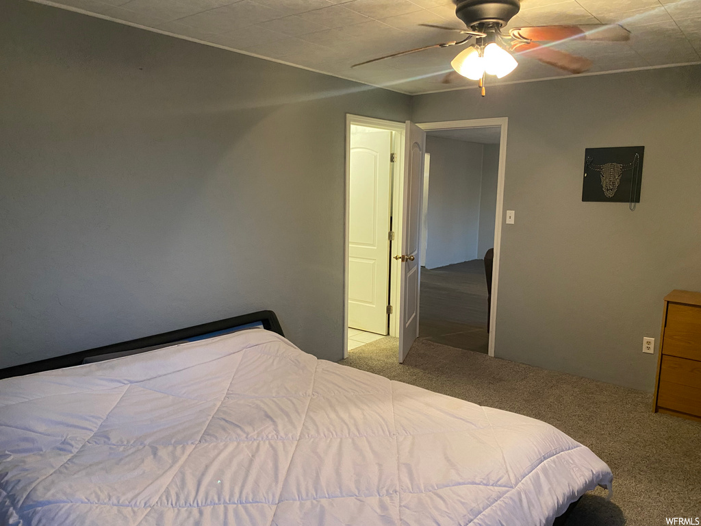 Bedroom with light carpet and ceiling fan