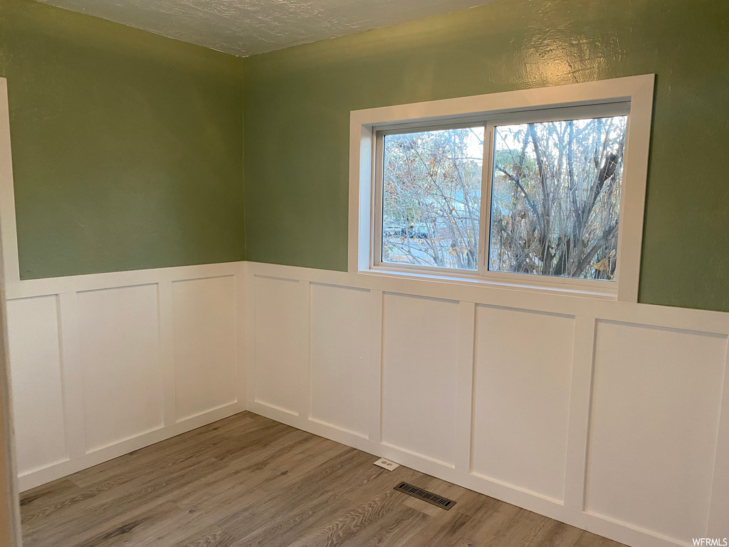 Empty room featuring light hardwood / wood-style flooring