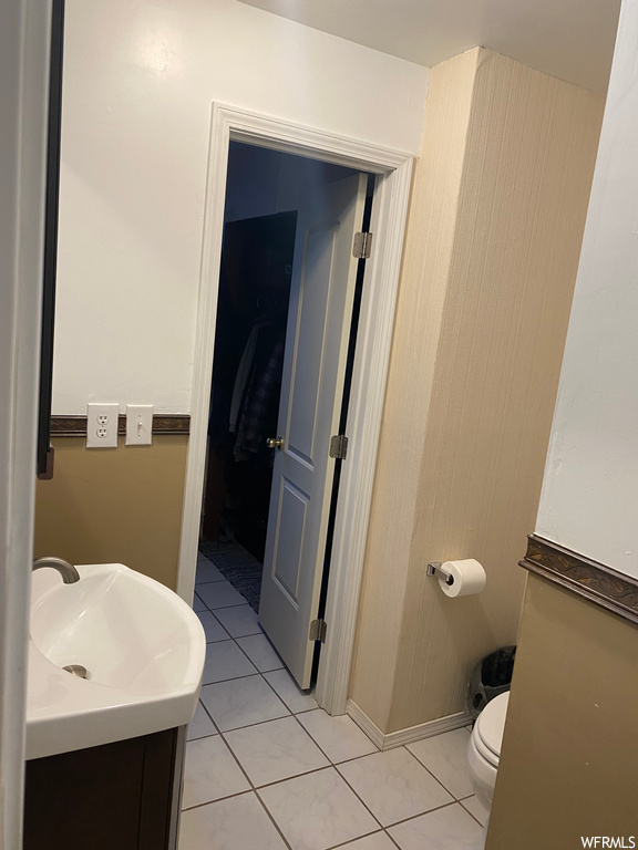 Bathroom with tile flooring, toilet, and vanity