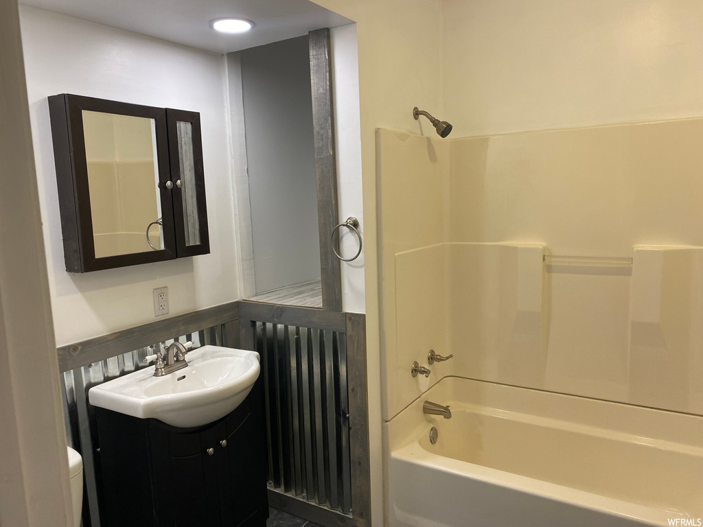 Full bathroom with vanity, shower / bathing tub combination, and toilet