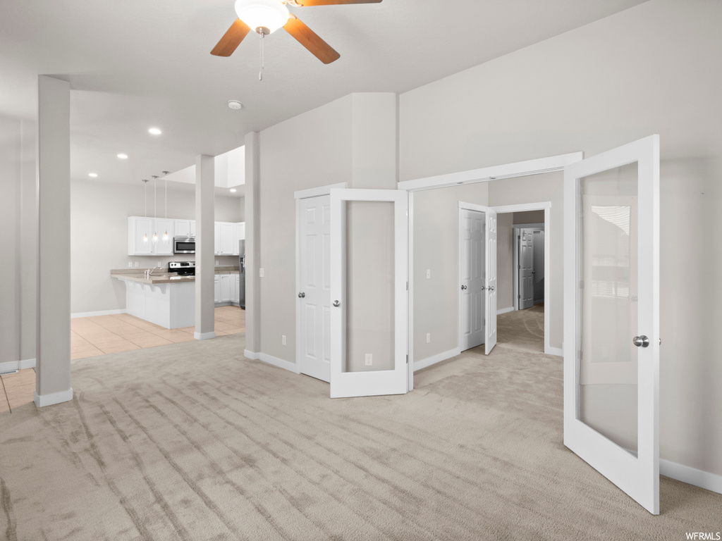 Interior space featuring french doors and ceiling fan