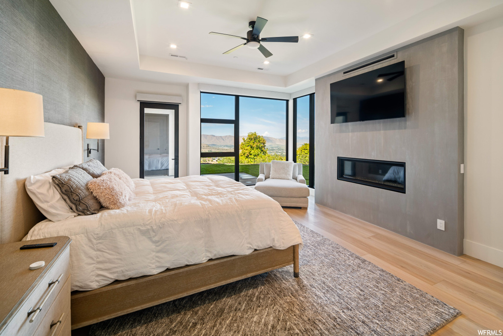 Bedroom featuring light wood-type flooring, ceiling fan, and access to exterior