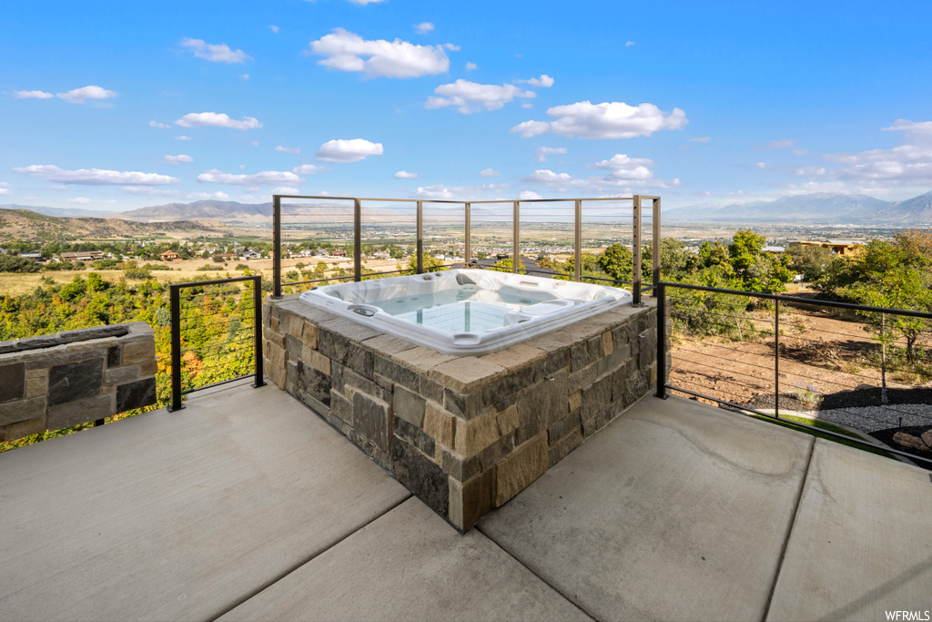 Exterior space featuring a mountain view and a hot tub