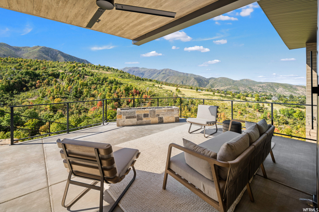 View of patio / terrace with a mountain view and ceiling fan