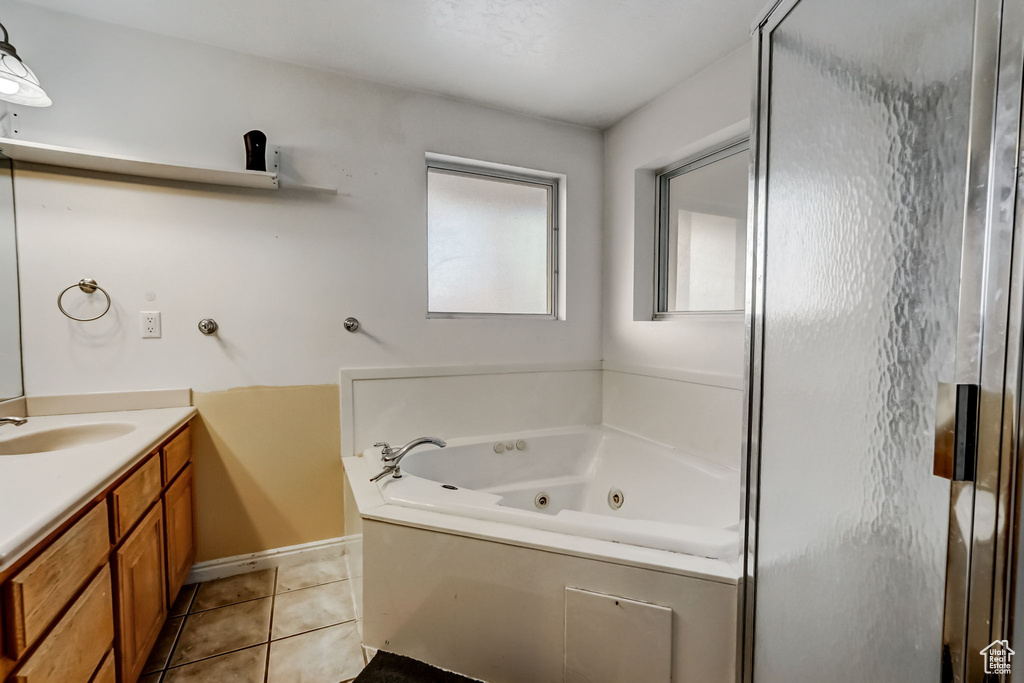 Bathroom featuring tile floors, a bathtub, and oversized vanity