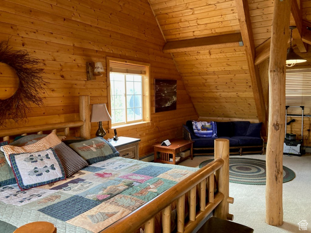 Carpeted bedroom with wooden ceiling, wooden walls, a baseboard heating unit, and vaulted ceiling