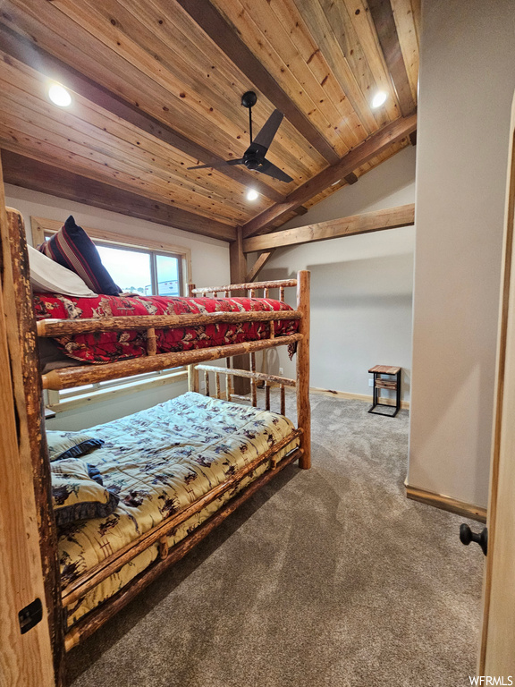 Bedroom with ceiling fan, carpet flooring, wood ceiling, and lofted ceiling with beams